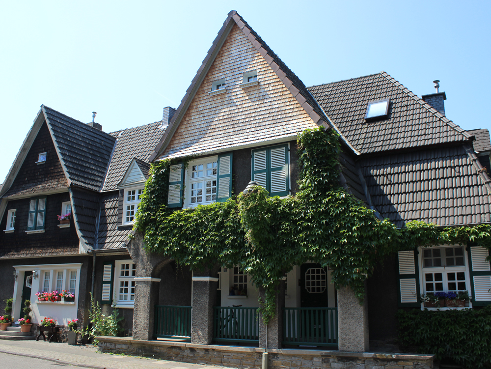 Wohnhaus Zweistöckiges Haus mit begrüntem Balkon und Satteldach in einer ruhigen Straße. Wohnhaus Margarethenhöhe Essen